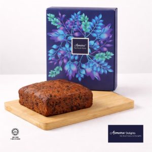 Front view of Kek Buah Kukus Asmara 710g whole cake with Asmara Delights gift box