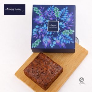 Top view of Kek Buah Kukus Asmara 710g whole cake with Asmara Delights gift box